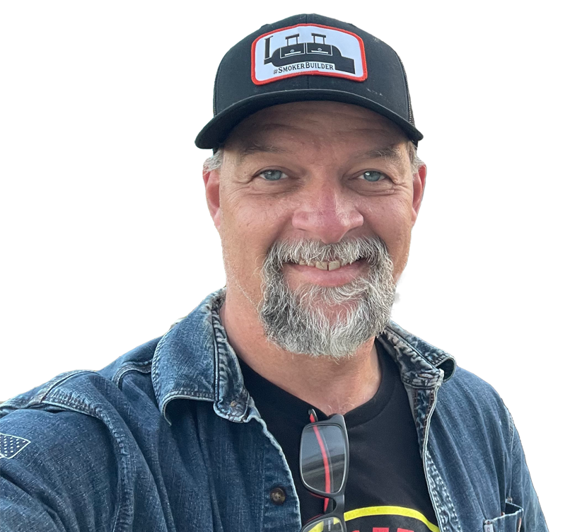 a man in a ball cap and blue jean shirt posing for a profile picture with a white background